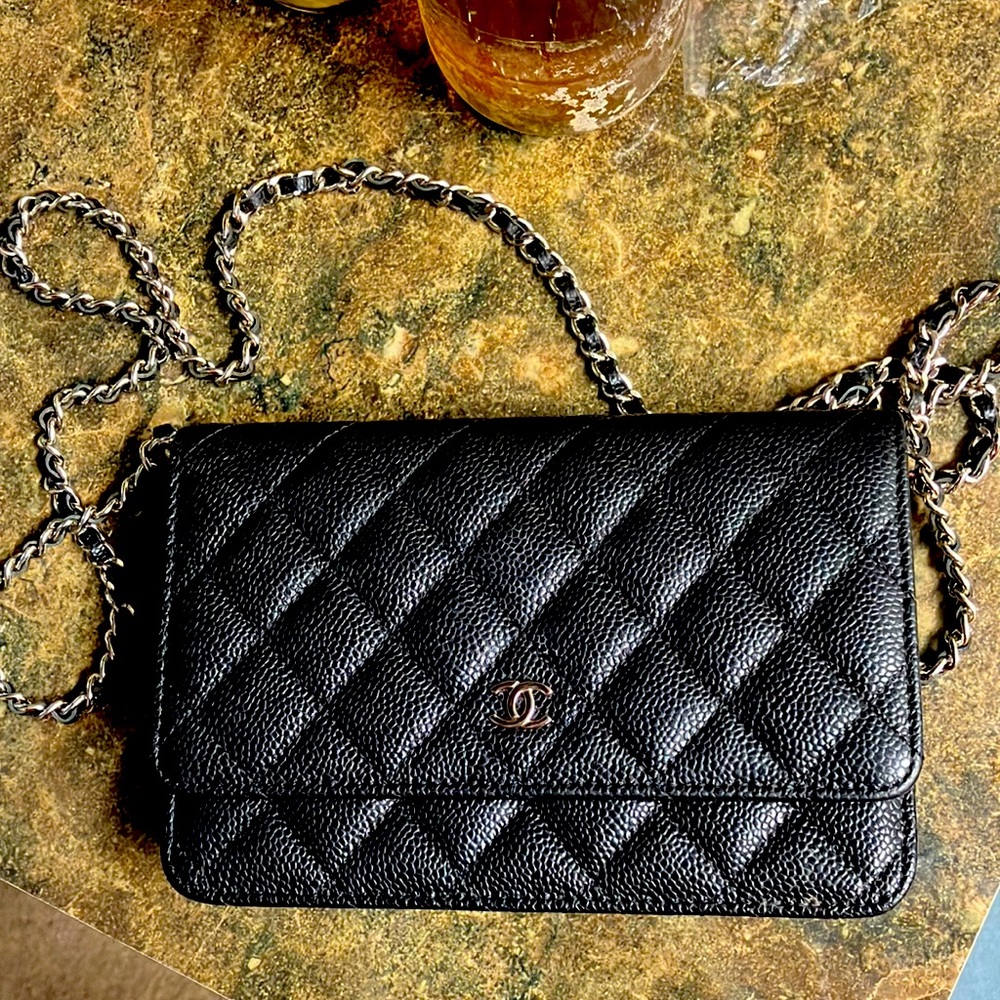 A black Chanel strap purse